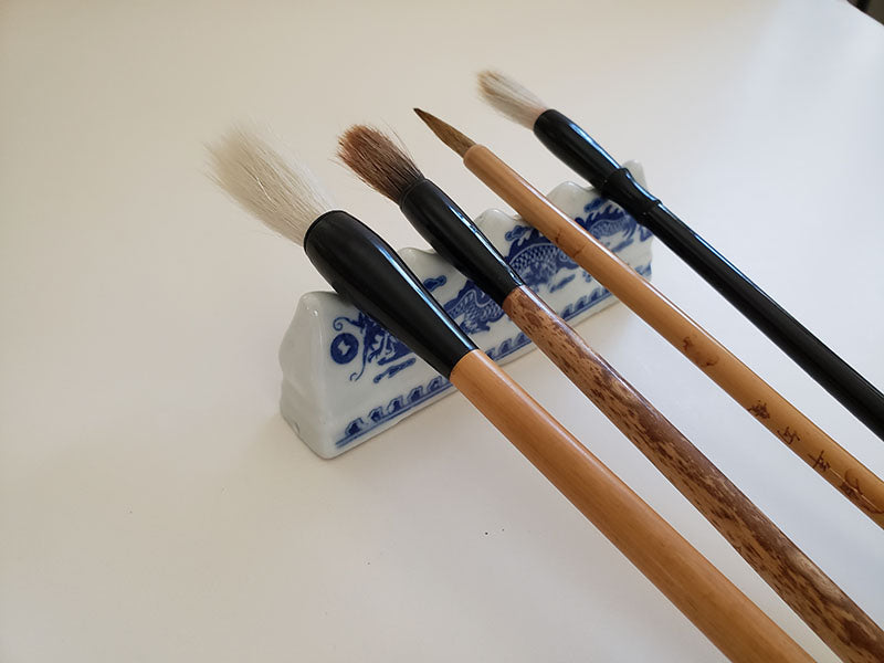 Blue and White Porcelain Brush Rest with Dragon Pattern: Essential Tool for Traditional Artistry